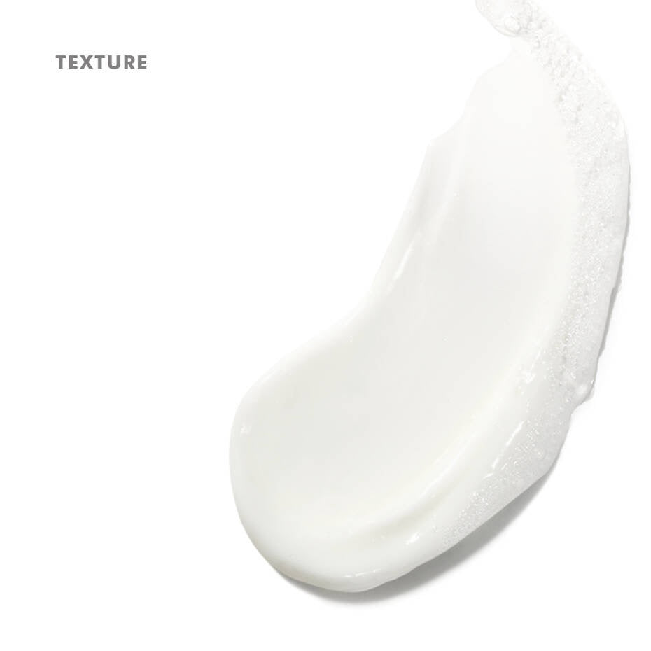 Close-up of a white cream texture on a light gray background