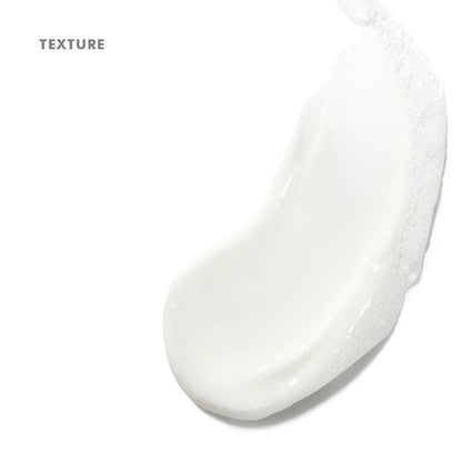 Close-up of a white cream texture on a light gray background